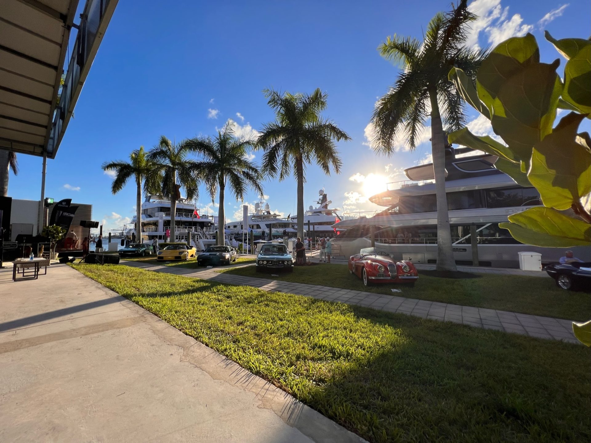 Marina with several superyachts and classic cars