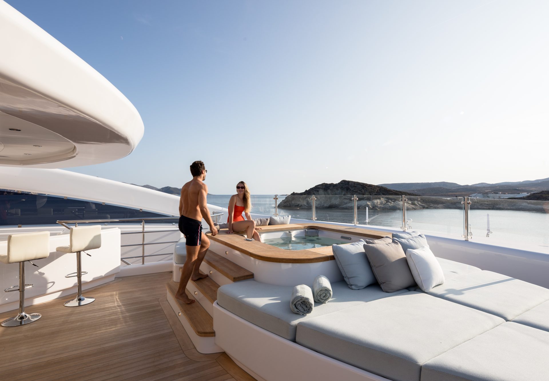 Couple enjoying hot tub on superyacht deck