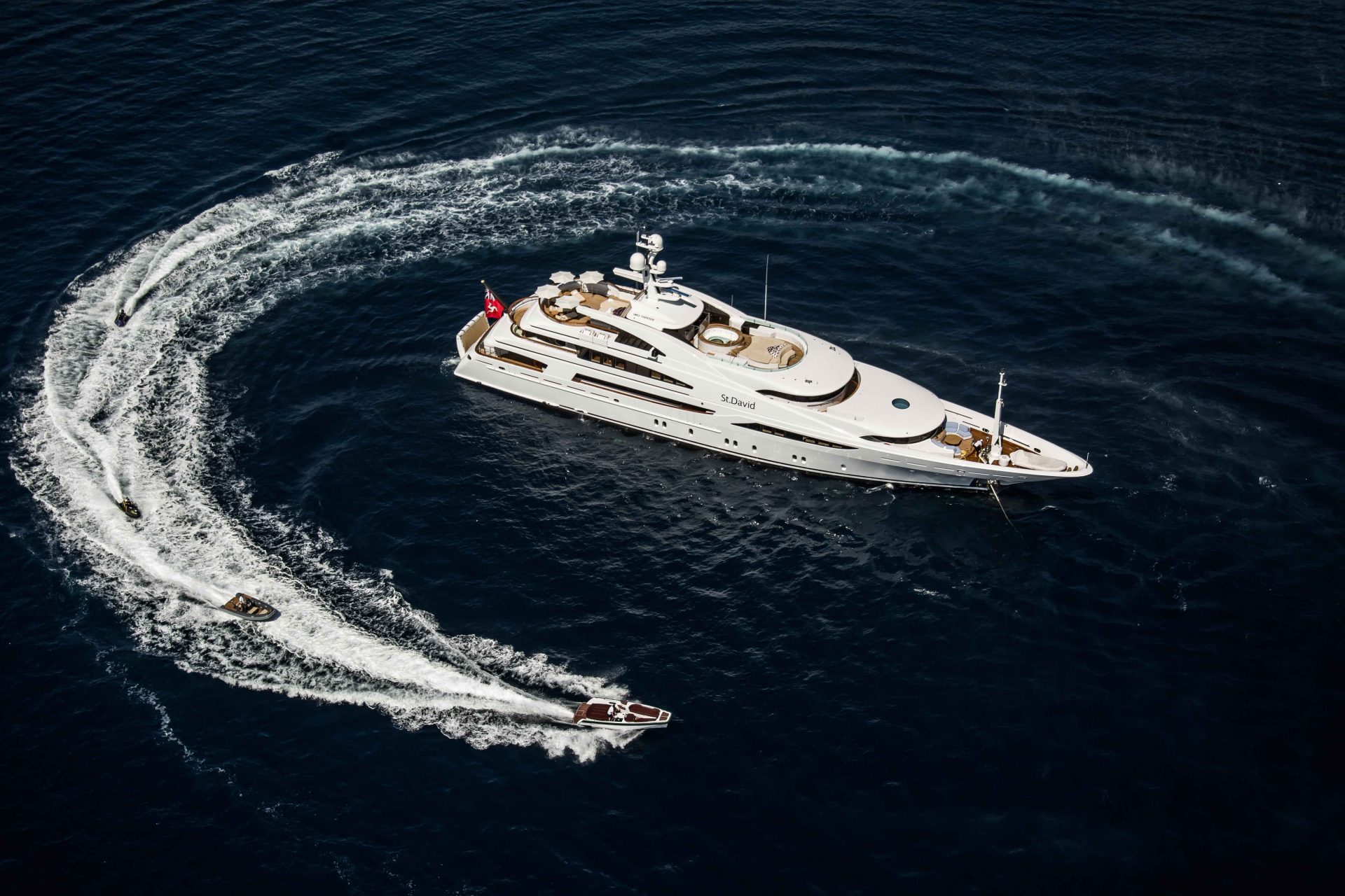 Superyacht with small boats in the ocean